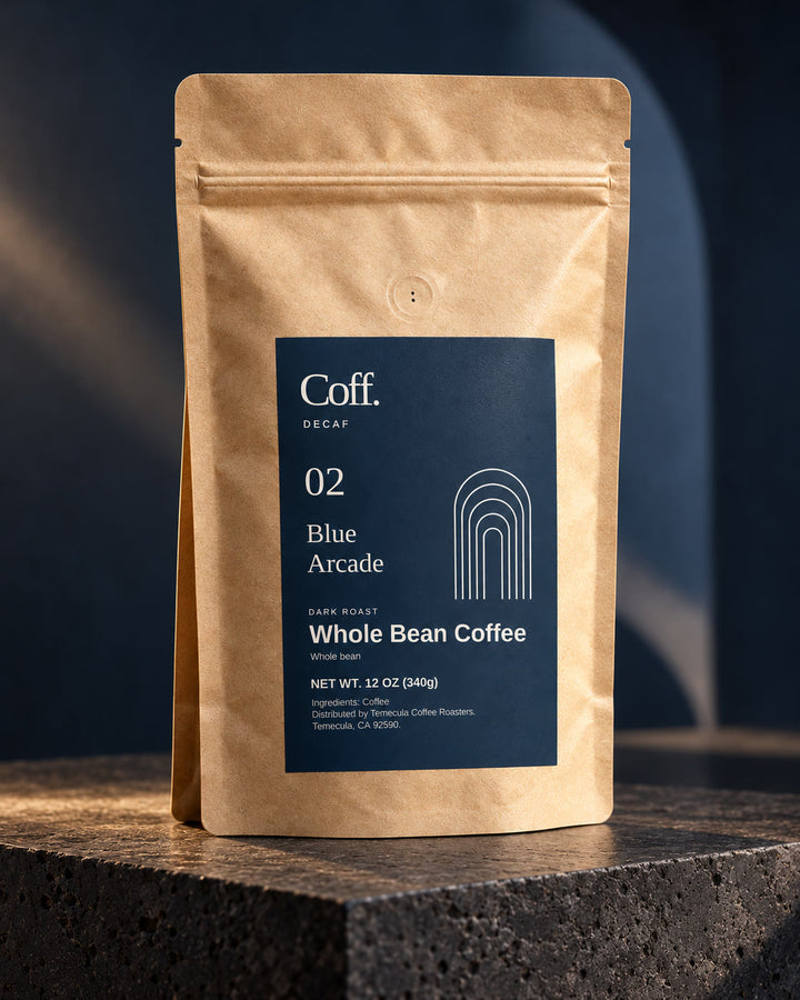 Illustrative studio view of Coff No. 02 Blue Arcade whole-bean decaf in a kraft bag with navy arch label.