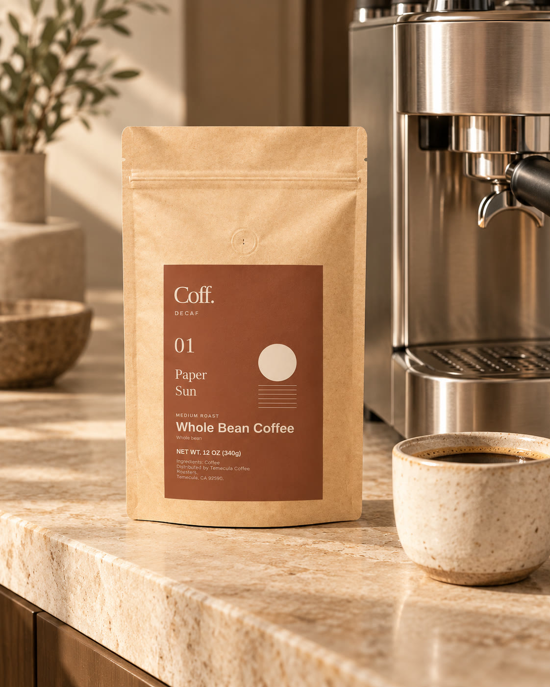 Illustrative home countertop scene with Coff No. 01 Paper Sun kraft bag beside an unbranded espresso maker.
