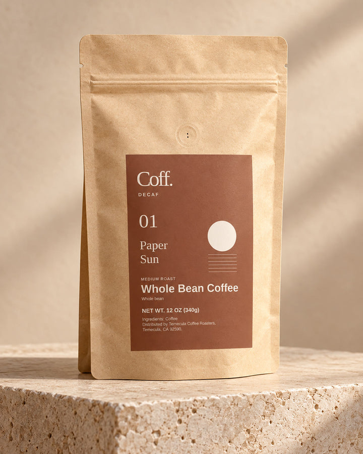 Illustrative studio view of Coff No. 01 Paper Sun whole-bean decaf in its kraft bag with clay sun label.